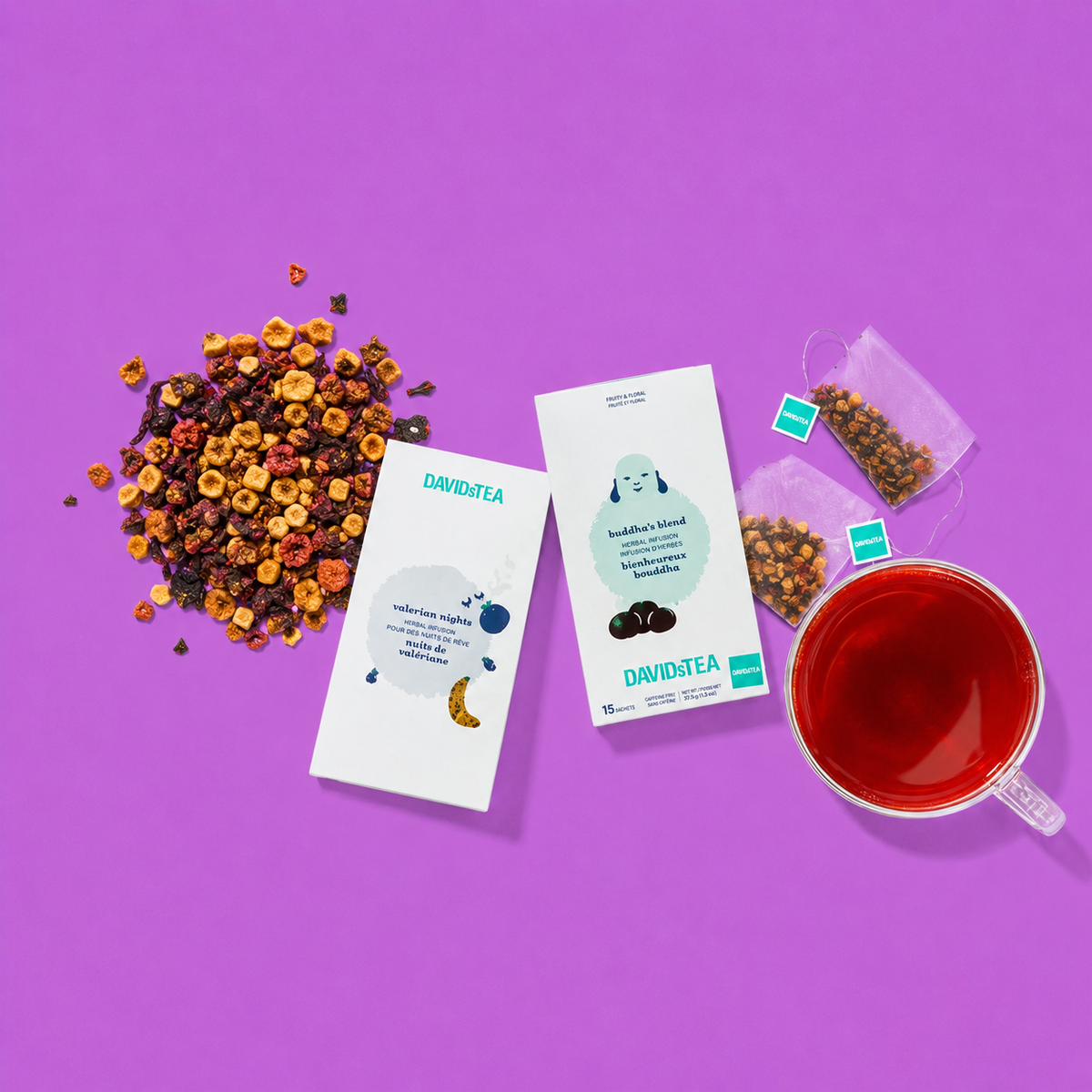 Tea sachet packages, loose leaf tea and a cup of red tea