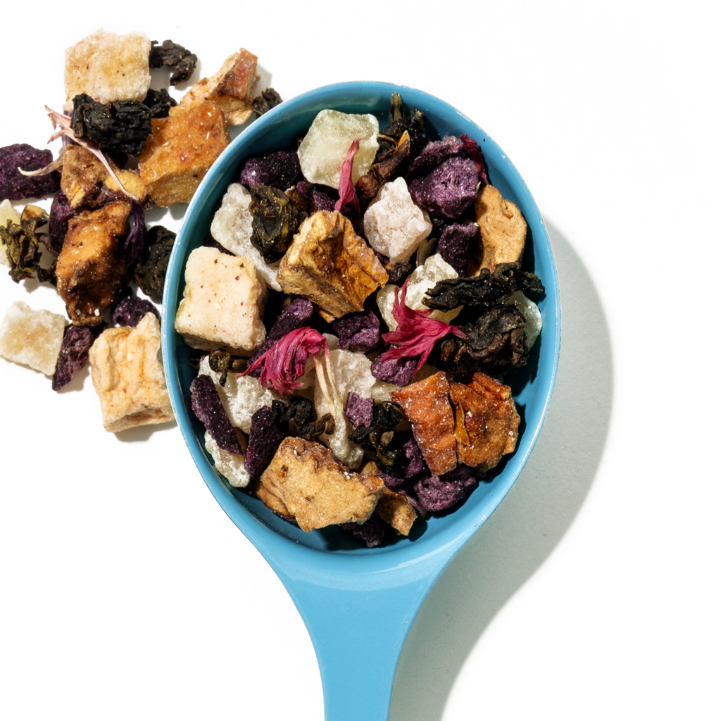 Guava Colada loose leaf tea in a blue spoon with fruit pieces