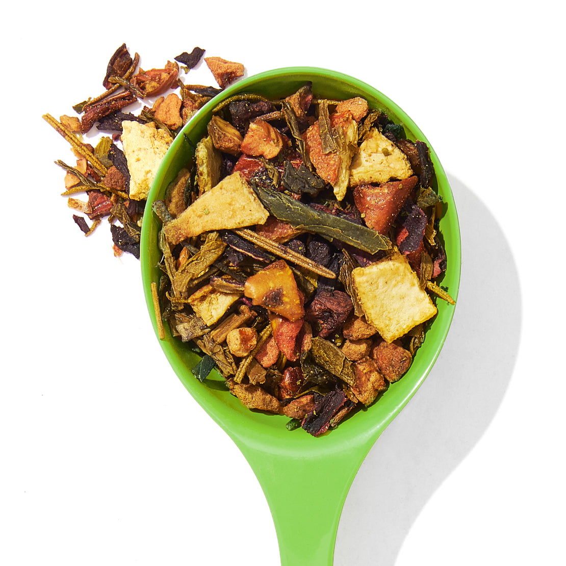 blood orange green loose leaf tea in a spoon