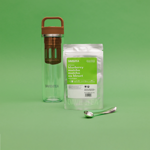 blueberry matcha 50 g bag with a brown matcha maker and matcha spoon. 