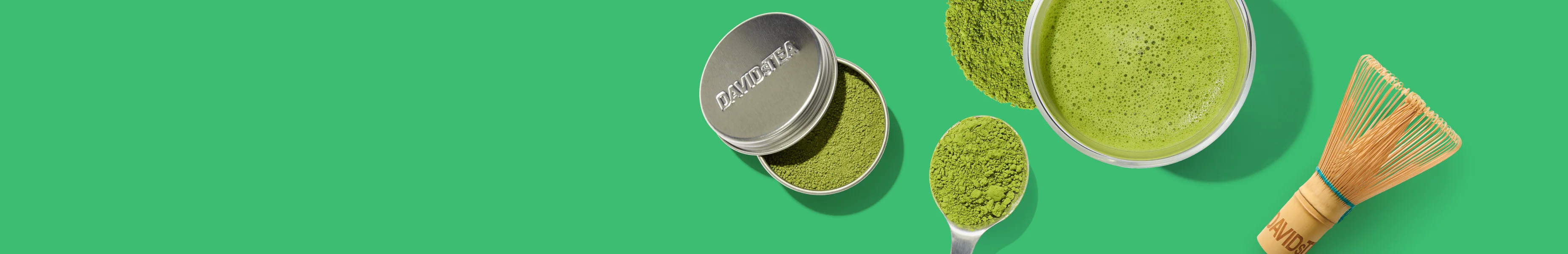 Matcha tin, whisk and a bowl of whisked matcha on a green background