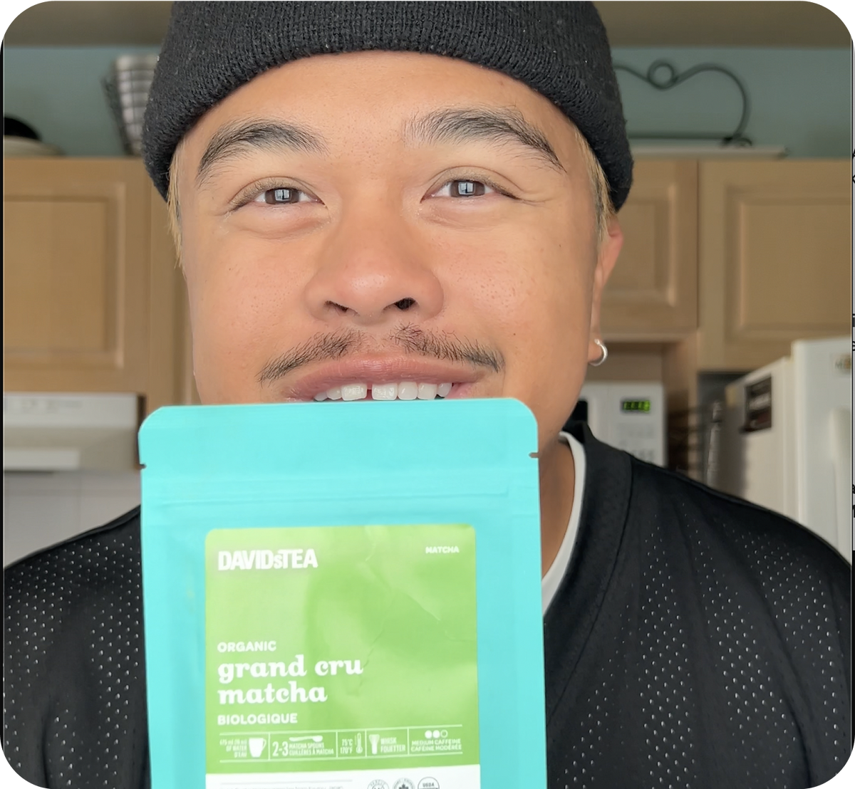 Person holding a green tea package